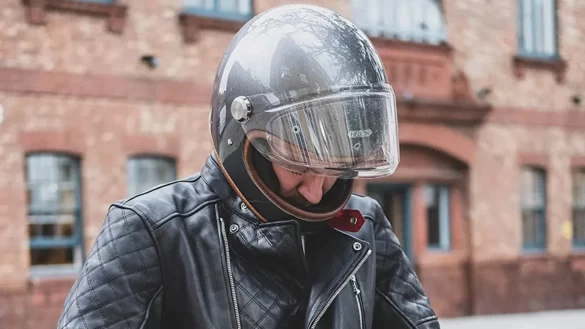 Rider wearing Goldtop Bobber black leather jacket with Hedon helmet
