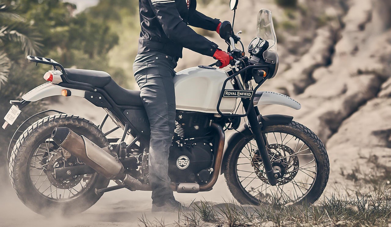 Rider with red gloves on Royal Enfield Retro Adventure Motorcycle