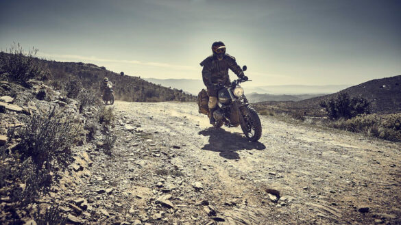 Rider on a BMW Scrambler wearing Old Western style overcoat