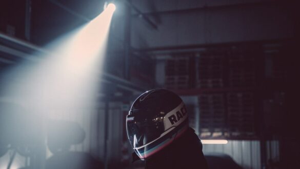 Spotlight shining on rider wearing Veldt Motorcycle Helmet