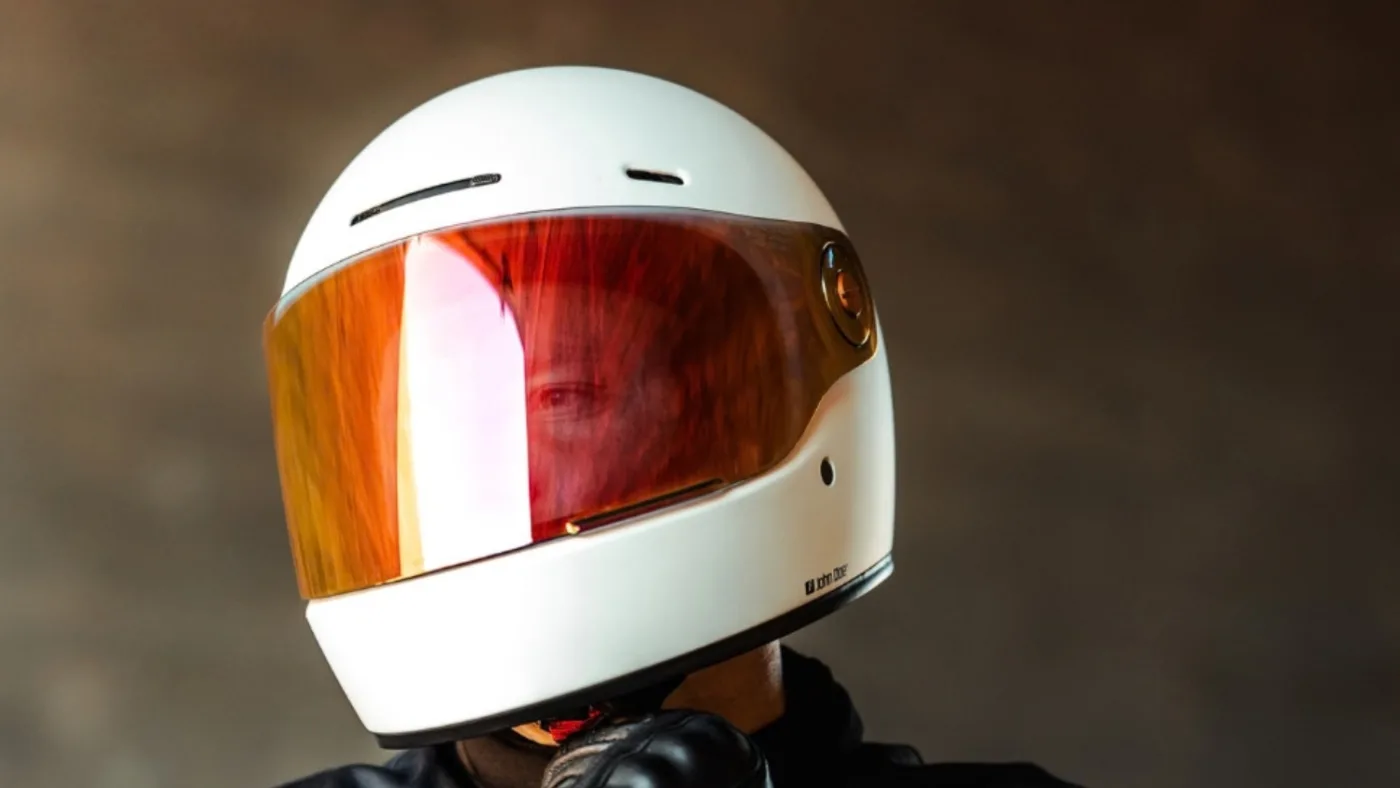 Best Retro Motorcycle Helmets 2026: Vintage Café Racer Style 14 Close-up of a John Doe J/D One Helmet in white with an orange visor