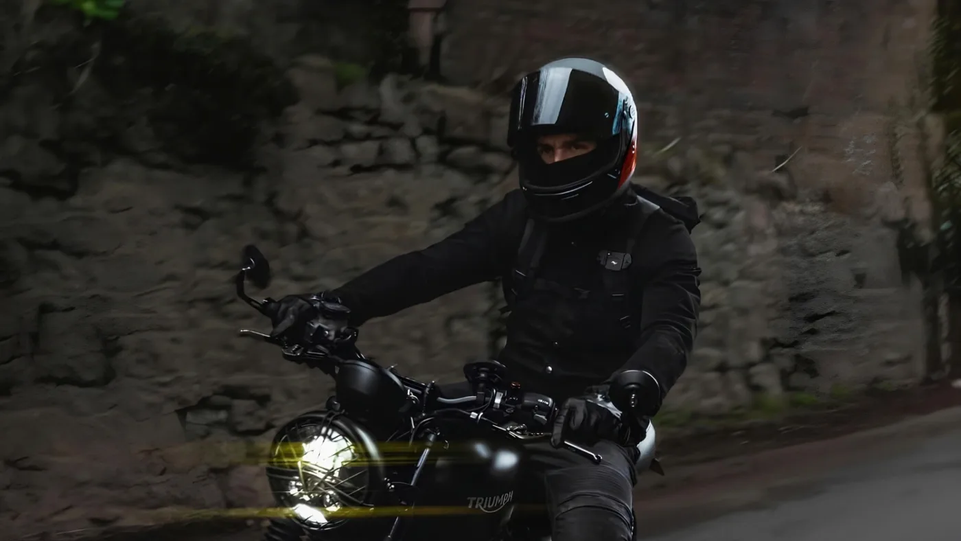 Best Retro Motorcycle Helmets 2026: Vintage Café Racer Style 16 Rider on a Triumph retro motorcycle wearing a DMD Rivale FUOCO helmet