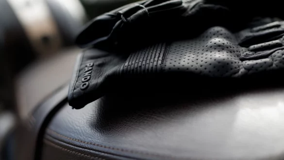 Gloves resting on a brown Triumph seat