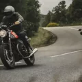 Rider on Moto Guzzi V7 Wearing a Nexx Helmet with another rider chasing on a Ducati Desert Sled