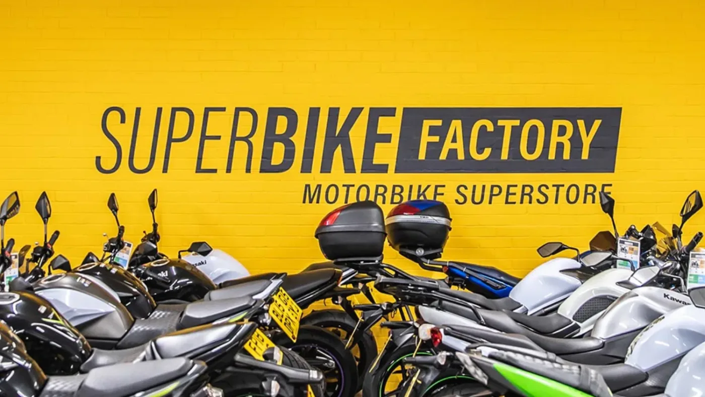 Colossal Collapse: SuperBike Factory No More - Suggestion of Inevitability 4 Superbike Factory Collapse - Logo background - Crown Interiors Donington Superbike Factory
