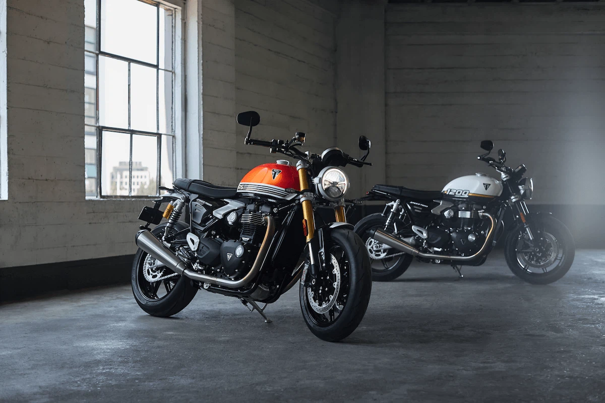 Bought Not Built: Speed Twin TFC - Triumph's Fifth Factory Custom 5 Speed Twin 1200 vs Speed Twin 1200 RS concrete background