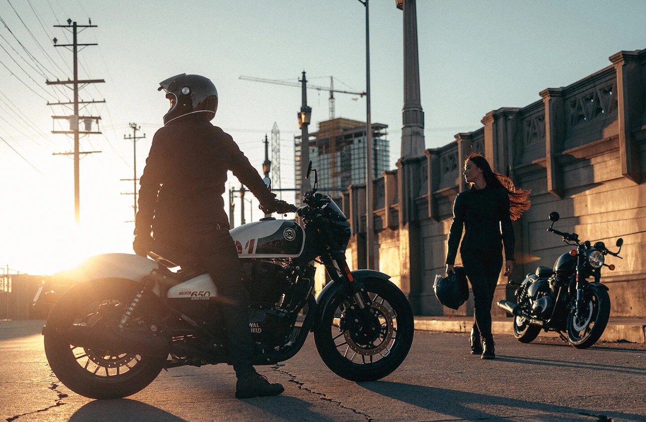 There Isn't Anything Rough about Rough Crafts x Shotgun 650 - Ultra-Limited Edition Royal Enfield 9 Rider sitting on a Standard Shotgun 650 in Stencil White while another rider walks past